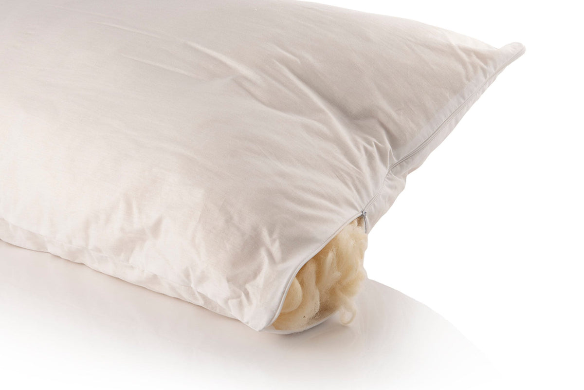 Elizabeth linen pillow styled with natural bedding and decorative cushions