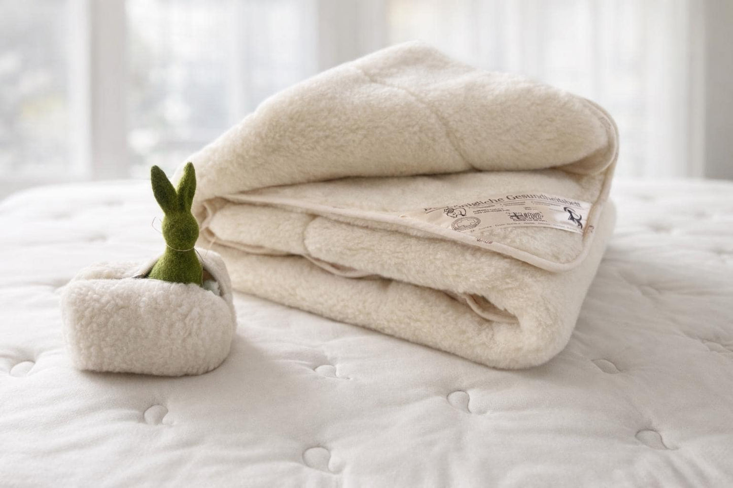 Folded Merino wool blanket with matching handmade cosmetic pouch